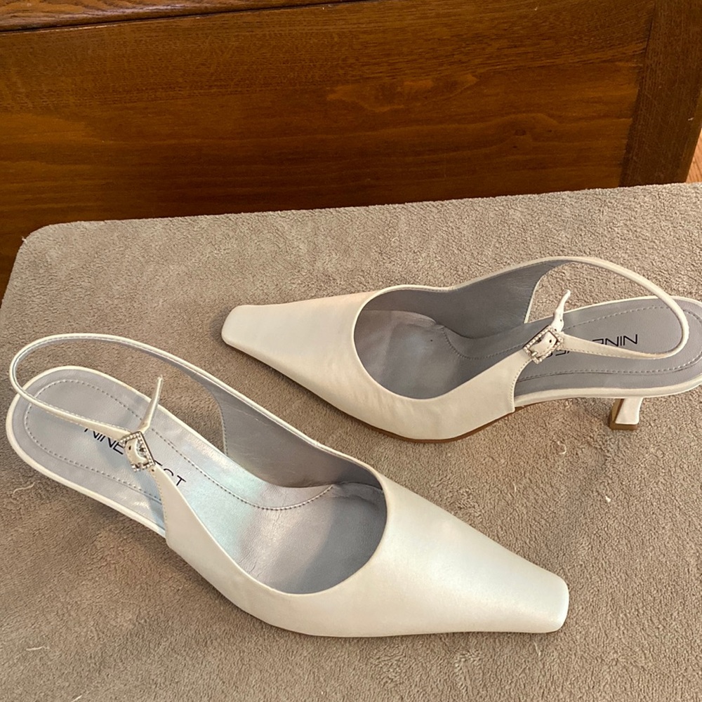 White silk sling back size 7and 1/2. The pump has a 2 and 1/2 inch heel. New